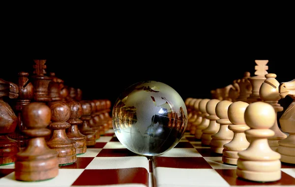 Chess figures against earth globe — Stock Photo, Image