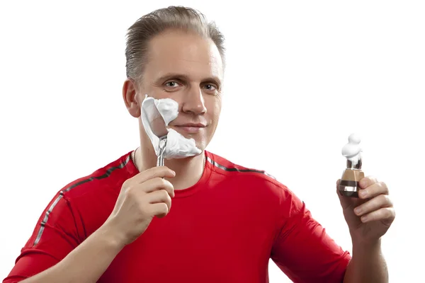 Man has a shave- with the razor and a small brush — Stock Photo, Image