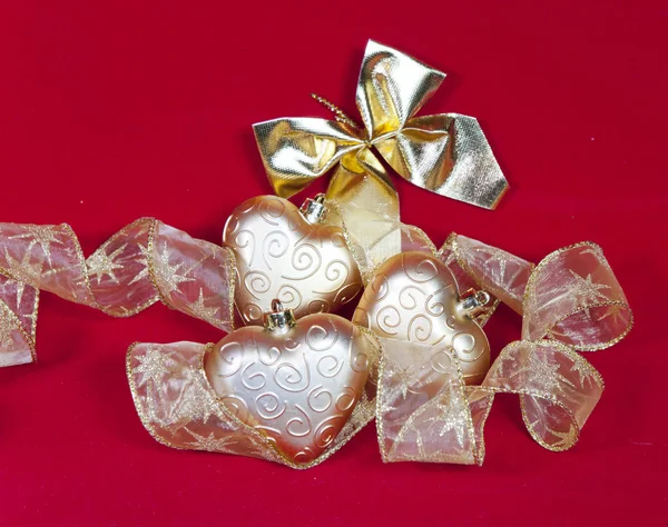 Gold New Year's hearts and decorative ribbon — Stock Photo, Image