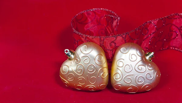 Gold New Year's hearts and decorative ribbon — Stock Photo, Image