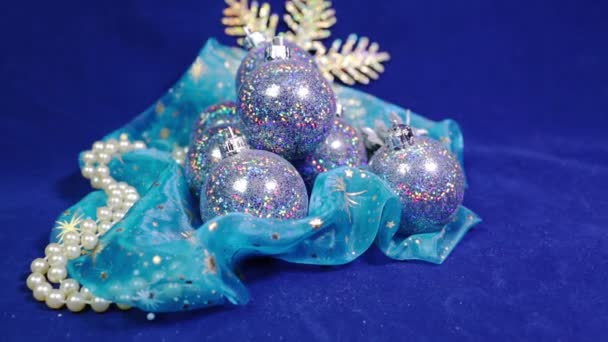 New Years balls and tinsel on a blue background — Stock Video