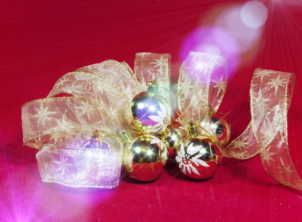 New Year's composition on a red background - ball and ribbon — Stock Photo, Image