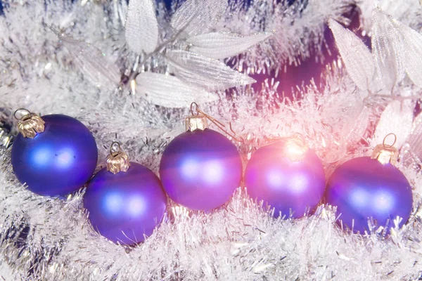 Blue New Year's balls and tinsel on a blue background — Stock Photo, Image