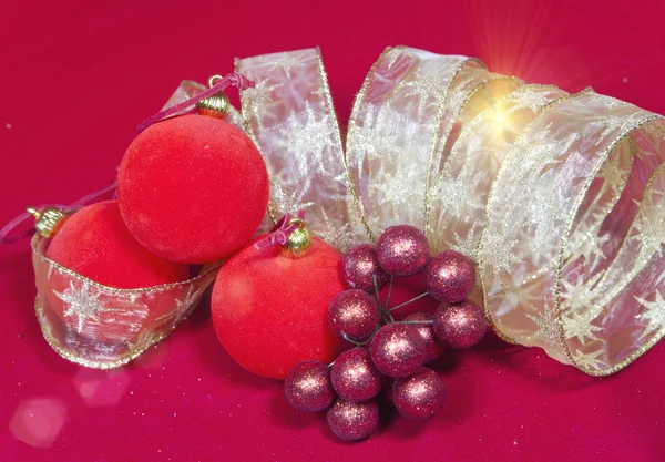 New Year's composition on a red background - ball and ribbon — Stock Photo, Image