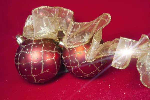 New Year's composition on a red background - ball and ribbon — Stock Photo, Image