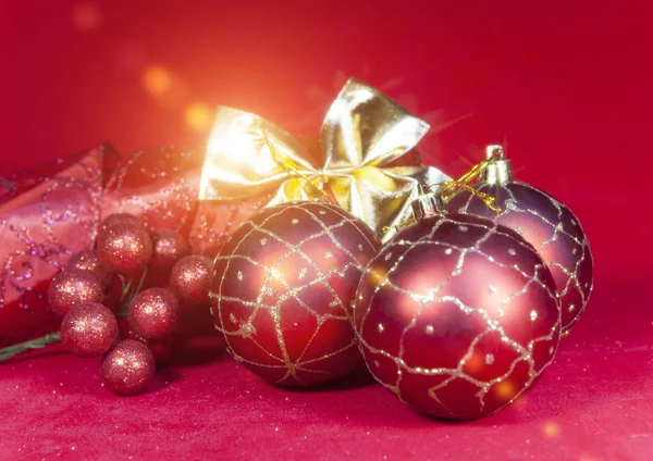 New Year's composition on a red background - ball and ribbon — Stock Photo, Image