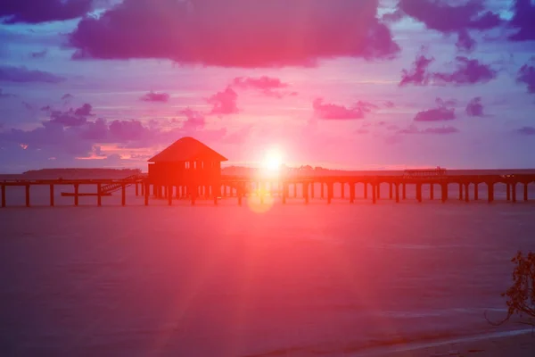 Silhouettearbor over water for rest at sunset — Stock Photo, Image