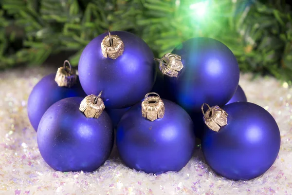 Blue New Year's balls on a background of decorative snow Stock Image
