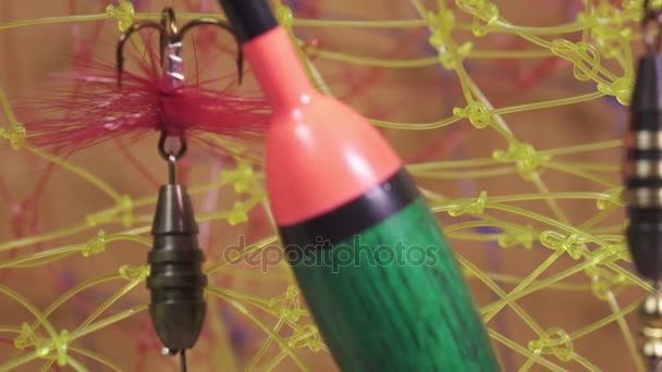 Float and baits on a fishing net background — Stock Video