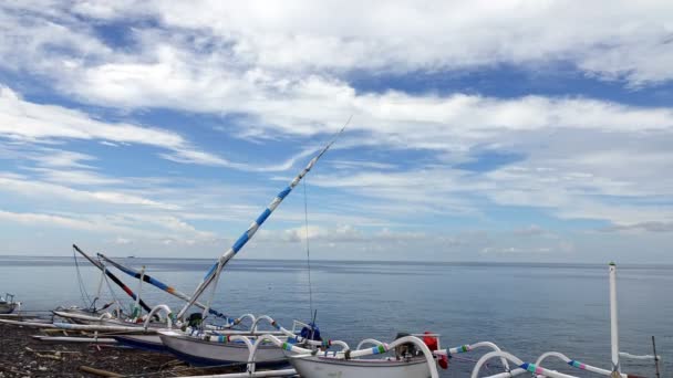 Time-lapse. Tradichionny boten van vissers op de kust en wolken drijvend op sky waterbeheersing Bali. Indonesië — Stockvideo