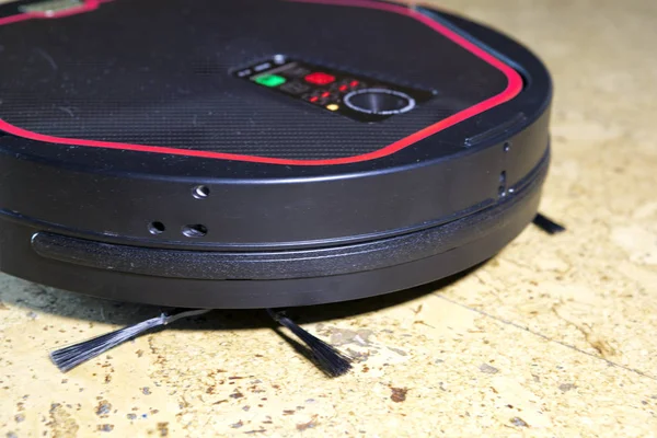 the robot the vacuum cleaner cleans a floor, a fragment with brushes