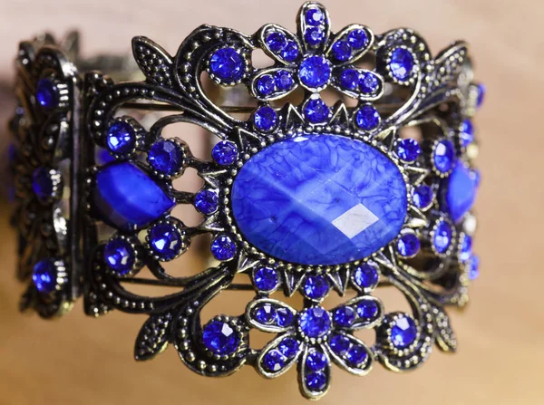 Beautiful Bracelet Blue Jewel Wooden Background Standard Mass Production — Stock Photo, Image