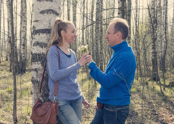 Man Gives Woman Bouquet Snowdrops Birchwood Spring Tonin — Stock Photo, Image