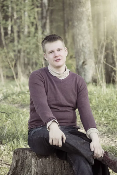 Young Man Sits Wood Stub Retro Effec — Stock Photo, Image