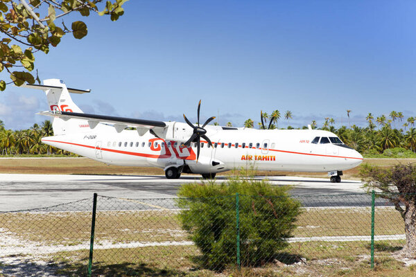POLINESIA- JUNE 16:  screw plane - ATR 72 Air Tahiti companies makes landing on the small tropical island Tikehau on june 16, 2011 in French Polynesia