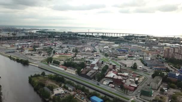 Drone view of the industrial part of St. Petersburg, Kanonersky island with Western high-speed diameter and the Gulf of Finland on the horizon.shot in 4K UHD — стоковое видео