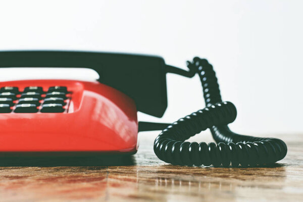 Old fashioned telephone with receiver on the hook.