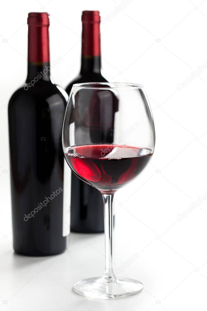 Glasses of red wine on white background.