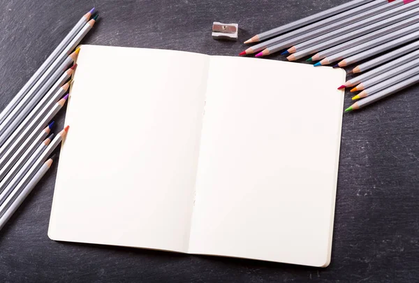 blank paper for drawing and colorful pencils