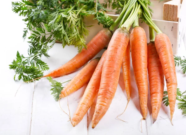 fresh carrots on wooden table