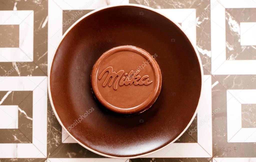 DORKOVO, BULGARIA - DECEMBER 12, 2017: close-up bar Milka old wooden background, alpine milk chocolate. Illustrative editorial