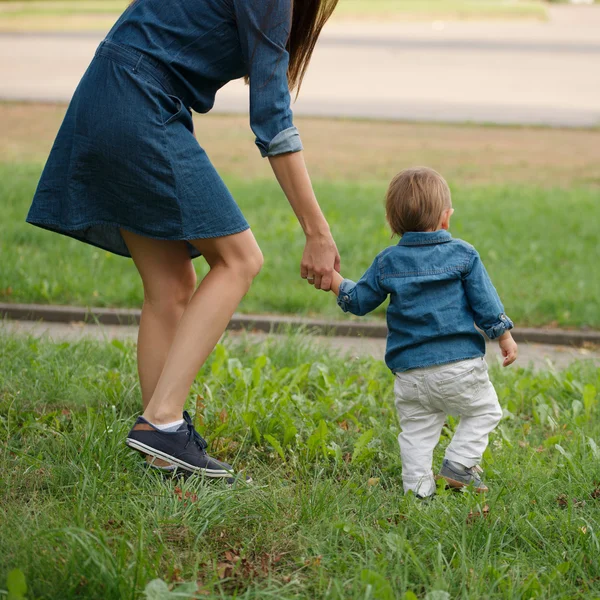 Mother holding son by hand — Stock Photo, Image