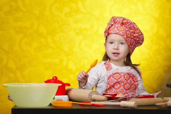 Little baker or cook girl cuts dough for cookies — Stock Photo, Image