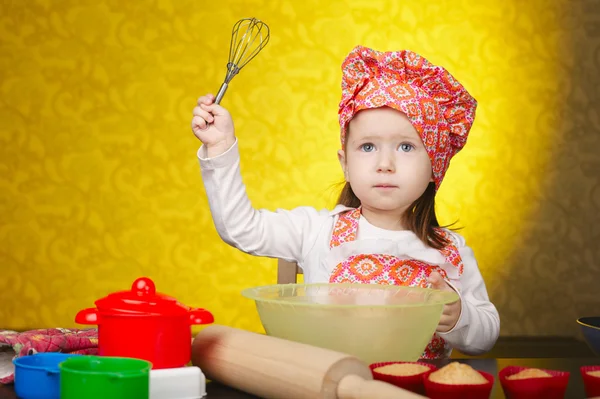 Little baker or cook girl cuts dough for cookies — Stock Photo, Image