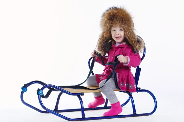 Little girl with sled on white background — Stock Photo, Image