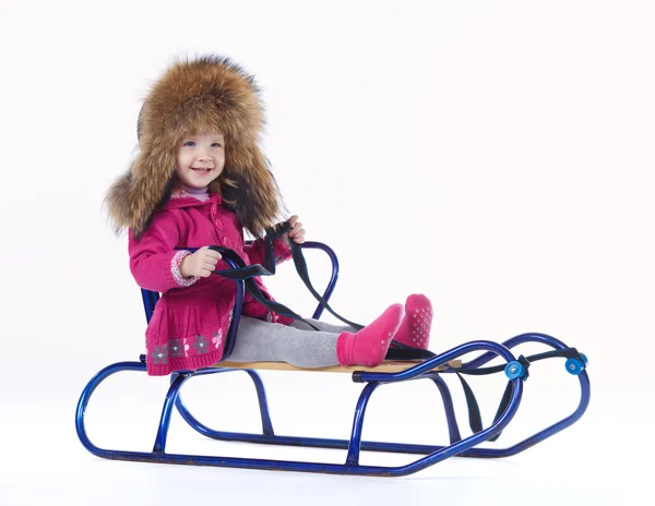 Little girl with sled on white background — Stock Photo, Image