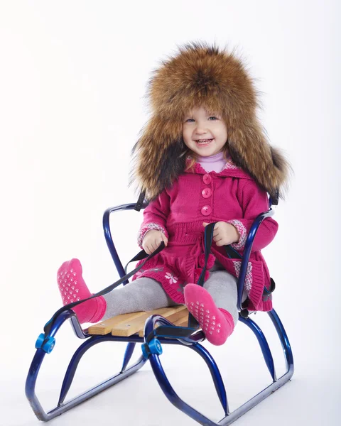 Little girl with sled on white background — Stock Photo, Image