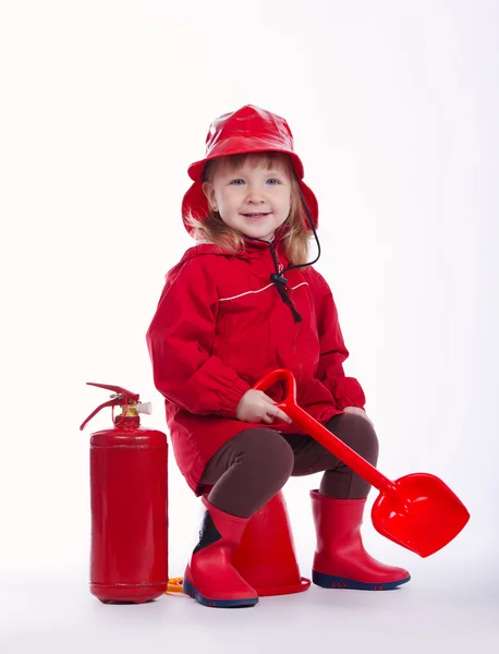 Pequeño bombero serio sobre fondo blanco — Foto de Stock