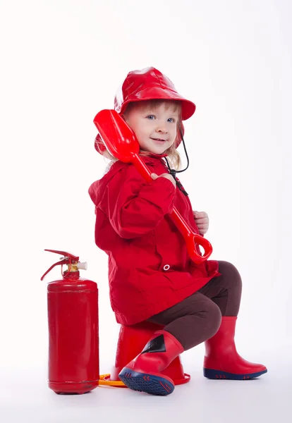 Pequeño bombero serio sobre fondo blanco — Foto de Stock