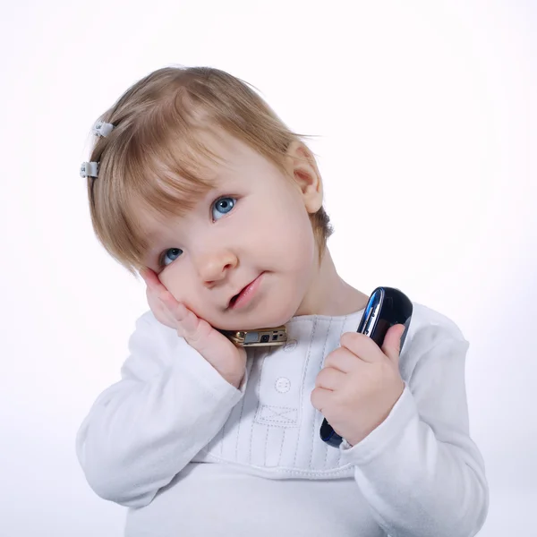 Little funny girl with two mobile phones — Stock Photo, Image