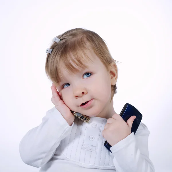 Little funny girl with two mobile phones — Stock Photo, Image