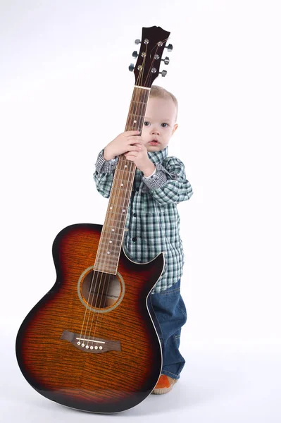 Kleiner Junge spielt Gitarre auf Weiß — Stockfoto