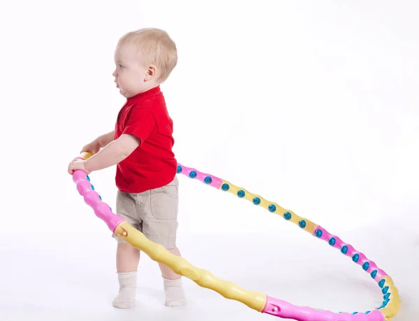 Beautiful funny child plays with hoop — Stock Photo, Image