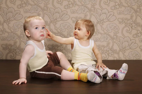 Little girl touches boy with finger — Stock Photo, Image