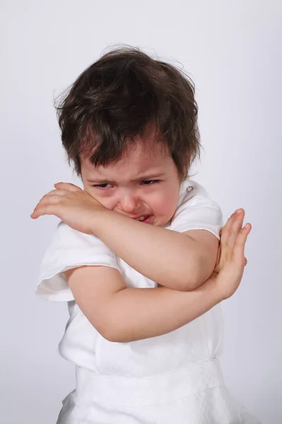 Симпатичный плачущий мальчик на белом фоне — стоковое фото