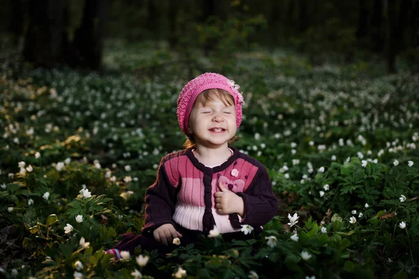 Beautiful little girl in forest on flowers field — Stock Photo, Image