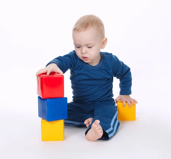 Boy plays with cubes on white Stock Photo