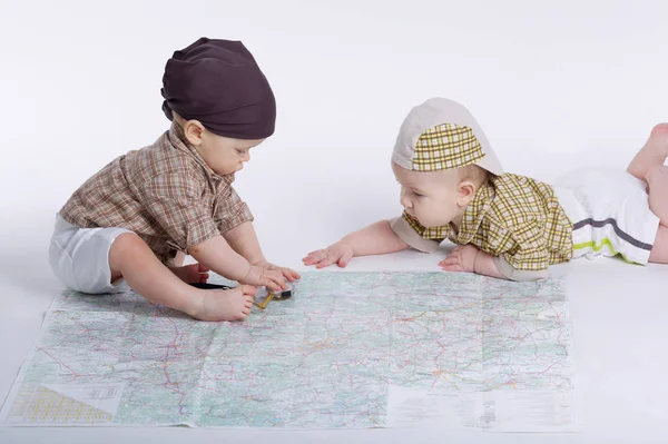 Cute babies planning travel with map — Stock Photo, Image