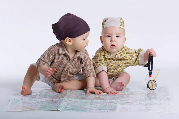 Cute babies planning travel with map — Stock Photo, Image
