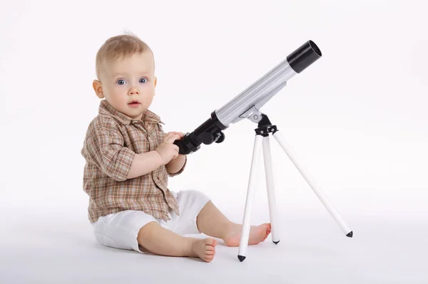 Little boy with telescope exploring stars — Stock Photo, Image