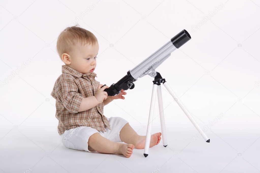 little boy with telescope exploring stars