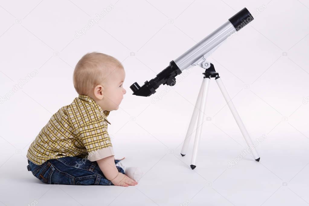 little boy with telescope exploring stars