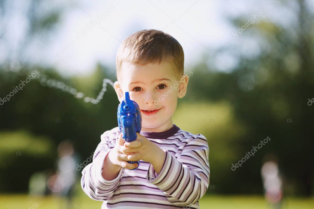 little boy with water gun