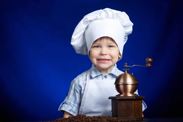 Little boy plays with coffee mill — Stock Photo, Image