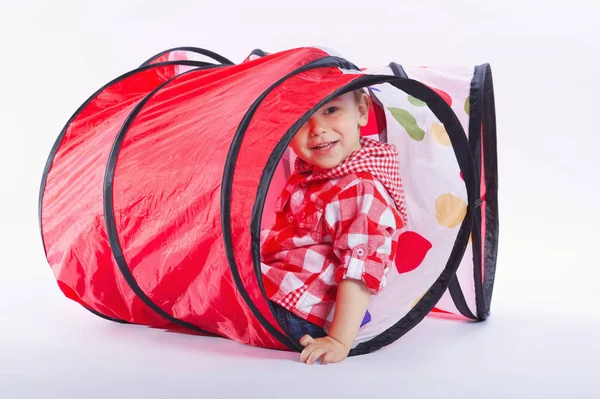 Happy boy plays with tunnel — Stock Photo, Image