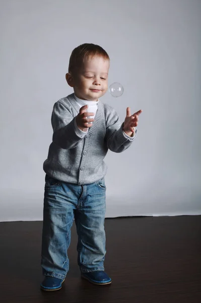 Little funny boy plays with bubbles — Stock Photo, Image